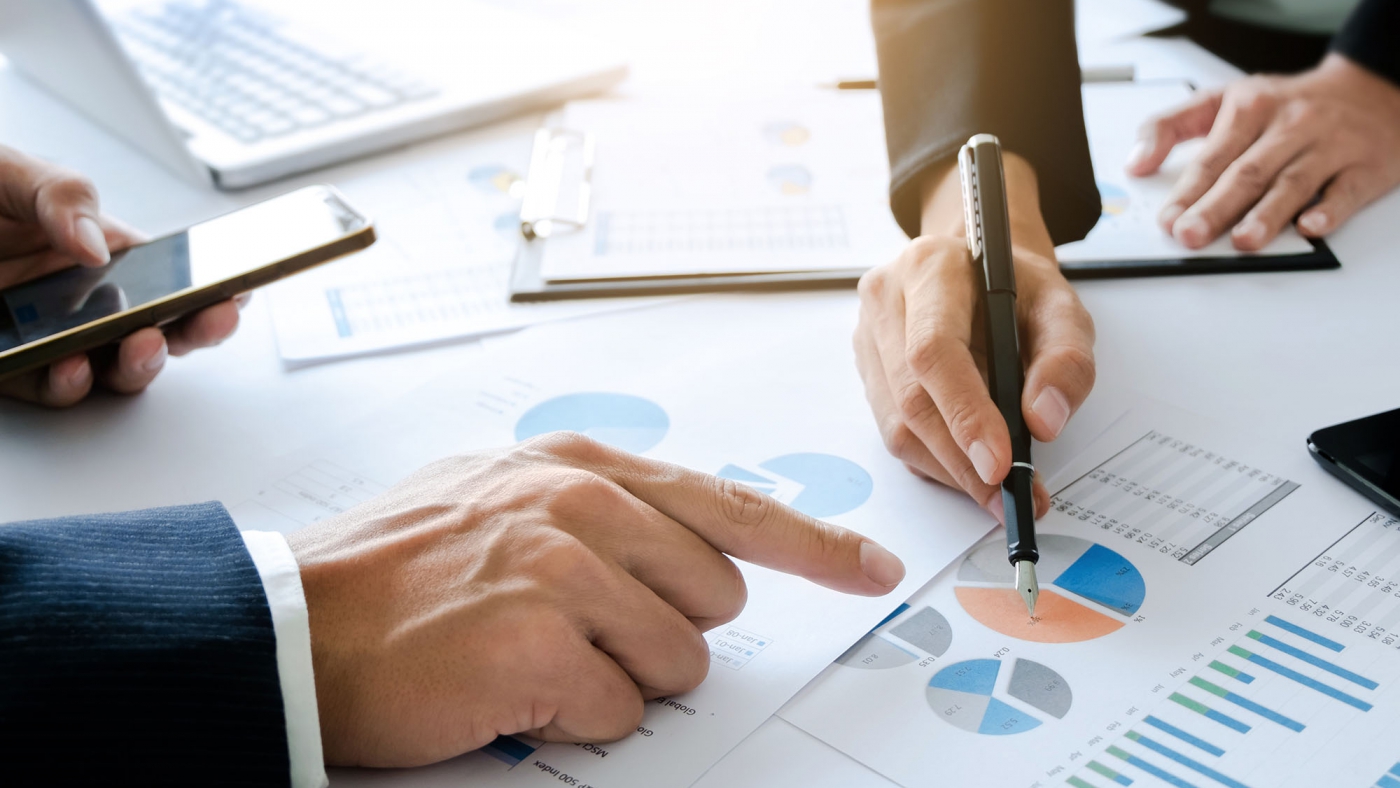 business executive colleagues working together with analysis data documents at a office