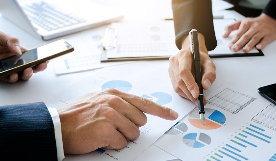 business executive colleagues working together with analysis data documents at a office